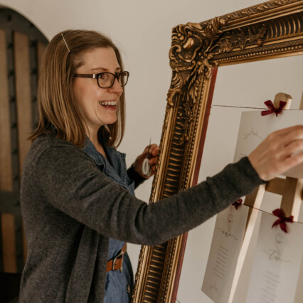 Simone Stationery Designer at Ellie and Liv hanging table plan cards in vintage gold frame